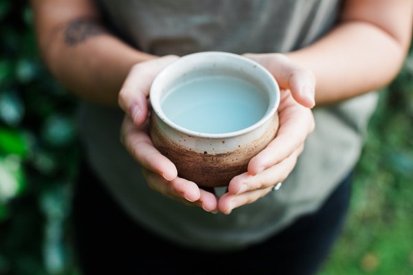 Hands holding a handmade ceramic cup